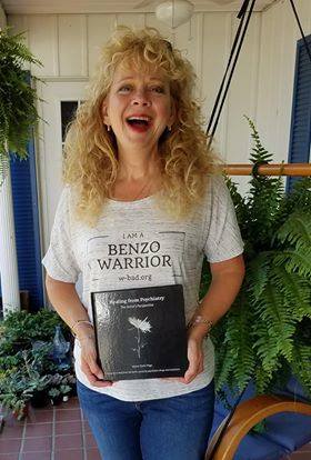 Salyann from West Virginia holding Healing from Psychiatry The Artist's Perspective Book by Alison